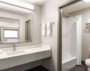 Guest bathroom at Days Inn By Wyndham San Antonio Near Fiesta Park.
