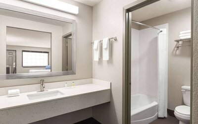Guest bathroom at Days Inn By Wyndham San Antonio Near Fiesta Park.