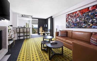 Day use suite with living area, fireplace, balcony and in-room kitchen at Montrose At Beverly Hills.