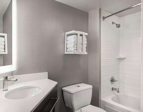 Private bathroom with combined shower and tub at Hampton Inn Chicago-O'Hare International Airport..