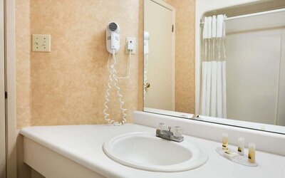 Guest bathroom at Days Inn By Wyndham Brantford.