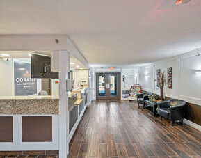 Reception desk at Coratel Plus Suites Wichita West Airport.