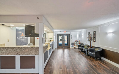 Reception desk at Coratel Plus Suites Wichita West Airport.
