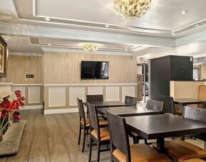 Lobby seating and restaurant at Lemon Tree Hotel & Suites Anaheim.