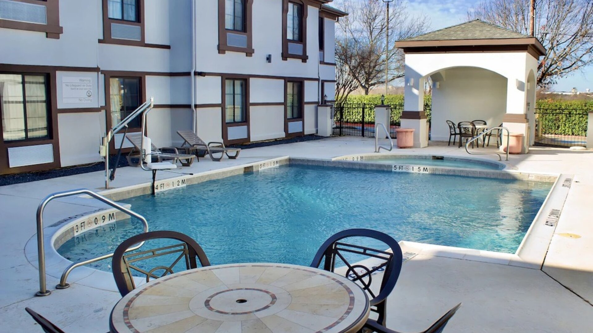 Outdoor pool at Quality Inn & Suites Irving DFW Airport South.