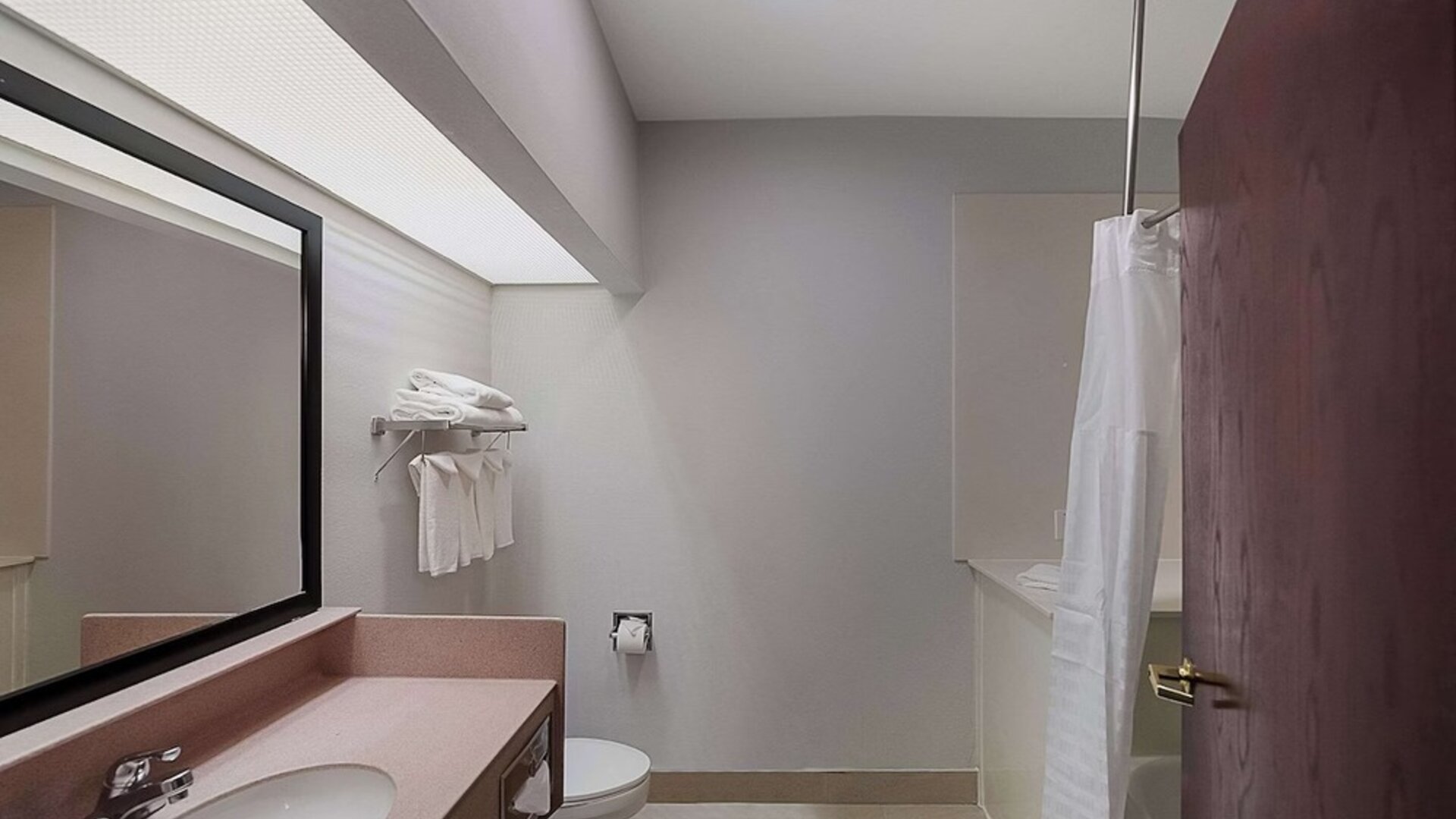 Guest bathroom at Quality Inn & Suites Irving DFW Airport South.