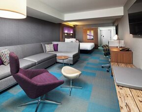 Day use room with living area and work desk at Aloft SFO.