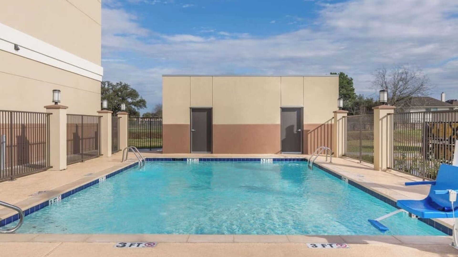 Outdoor pool at Days Inn & Suites By Wyndham Houston NW Cypress.
