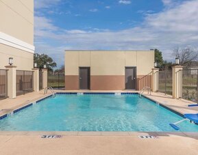 Outdoor pool at Days Inn & Suites By Wyndham Houston NW Cypress.