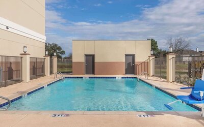 Outdoor pool at Days Inn & Suites By Wyndham Houston NW Cypress.