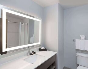 Guest bathroom at Days Inn & Suites By Wyndham Houston NW Cypress.