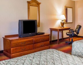 Work table beside the TV inside day use room at Rodeway Inn Huntington Station.