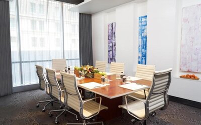 Professional meeting room with large table and ergonomic chairs at Hotel 48LEX New York.