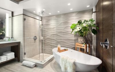 Private guest bathroom with combined shower and tub at Hotel 48LEX New York.