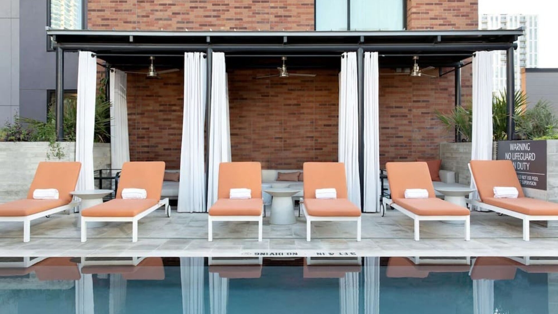 Outdoor pool and sun loungers at Canopy By Hilton Austin Downtown.