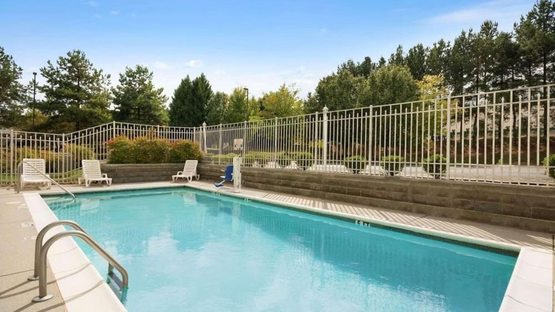 Outdoor pool at Country Inn & Suites By Radisson, Norcross, GA.