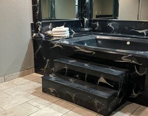 Bathroom at Island Suites Hobby Airport.