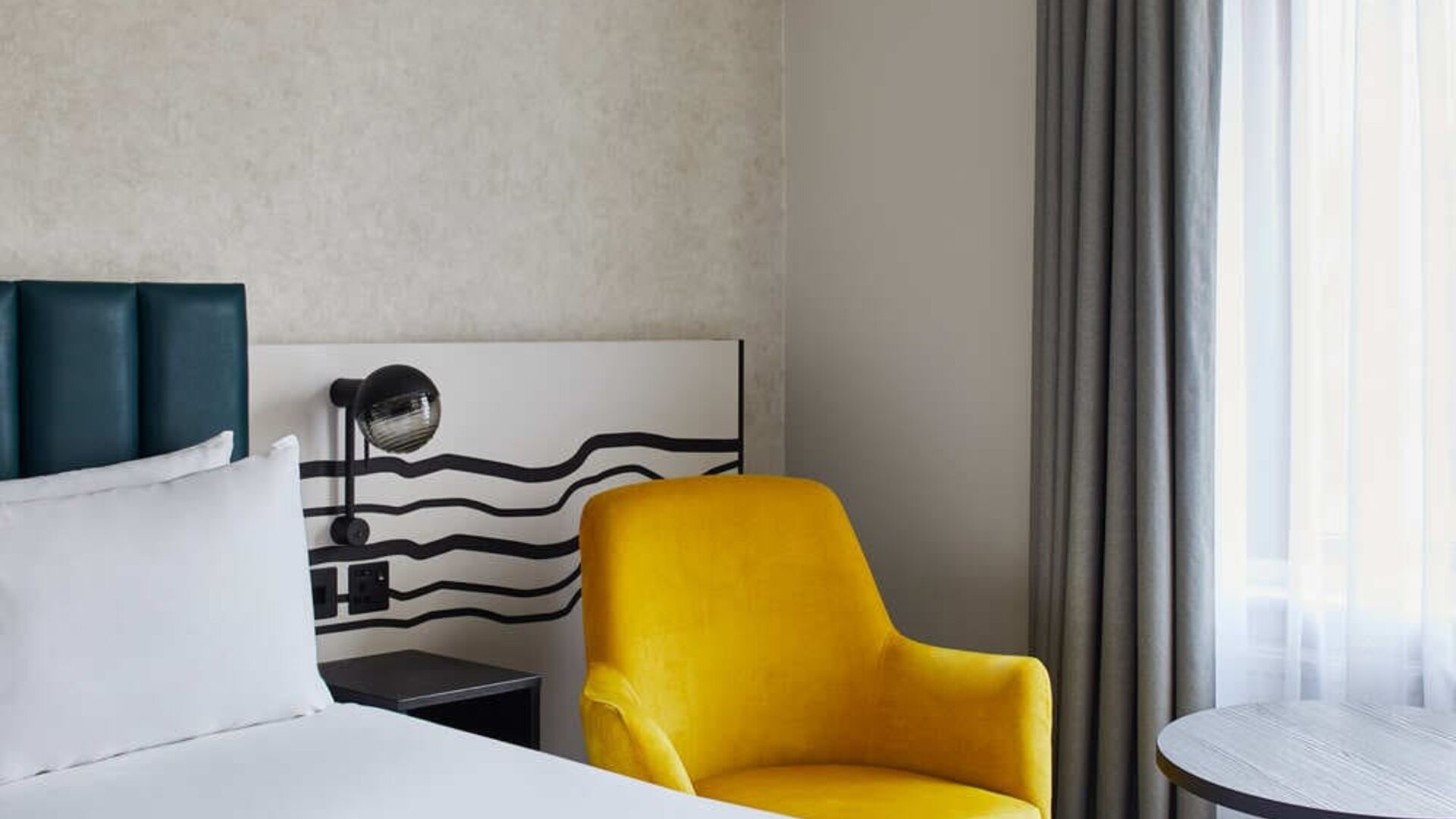 King room with chair at Leonardo Hotel Dublin Christchurch.