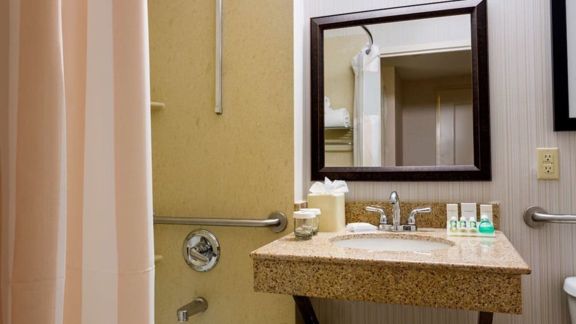 Bathroom at Hilton Garden Inn Tribeca with privacy curtains and plush towels.