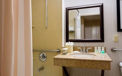 Bathroom at Hilton Garden Inn Tribeca with privacy curtains and plush towels.