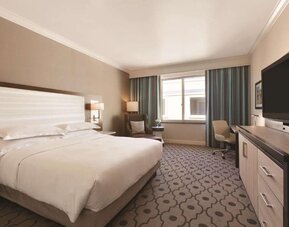 Comfortable day room with desk and chair at Hilton Los Angeles/San Gabriel for a relaxing daycation.