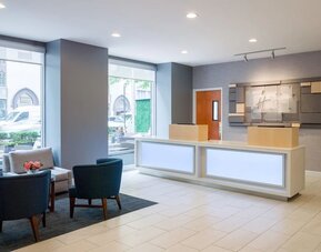 Reception at Holiday Inn Express New York City - Chelsea with comfortable seating.