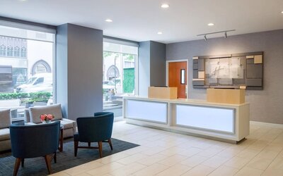 Reception at Holiday Inn Express New York City - Chelsea with comfortable seating.