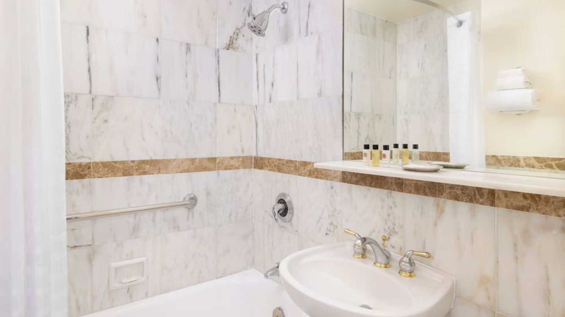 Modern bathroom with plush towels at New Yorker by Lotte Hotels