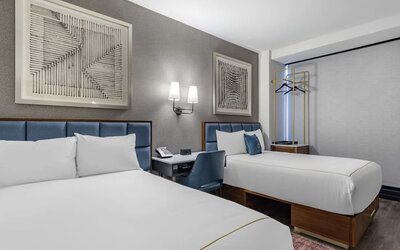 Guest room at The Draper Tapestry Collection By Hilton with workspace desk and chair.