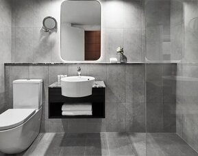 Guest bathroom with shower at Crowne Plaza Sydney Airport.