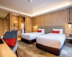 Day room with work desk and chair and natural light at Divalux Resort & Spa Bangkok Suvarnabhumi Airport.