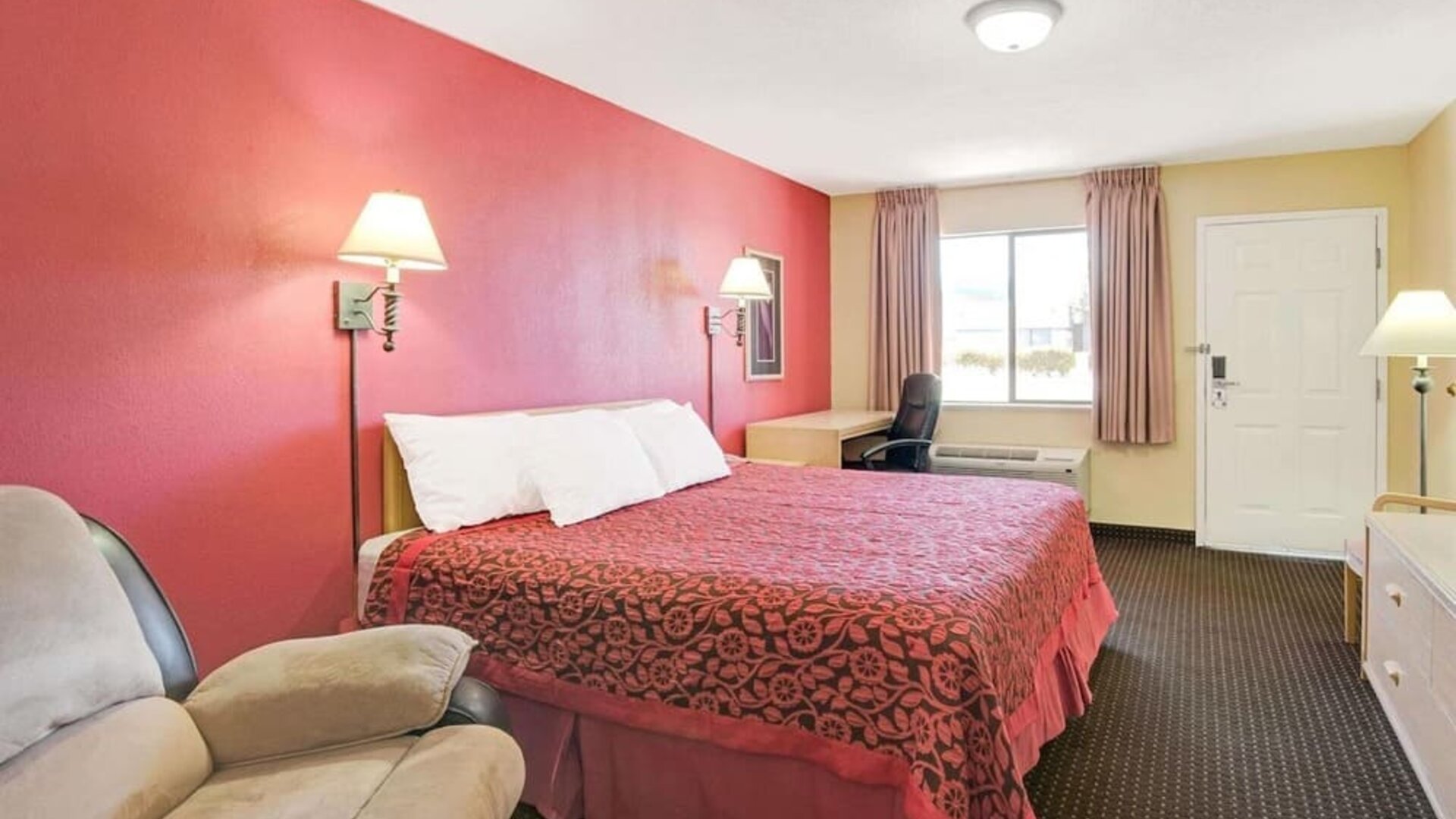 Day room with work desk and couch at Days Inn By Wyndham East Albuquerque.