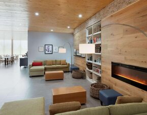 Lobby with a cozy fireplace and comfortable seating at Country Inn & Suites By Radisson, Katy - Houston West.