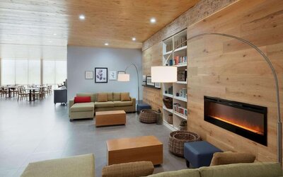 Lobby with a cozy fireplace and comfortable seating at Country Inn & Suites By Radisson, Katy - Houston West.