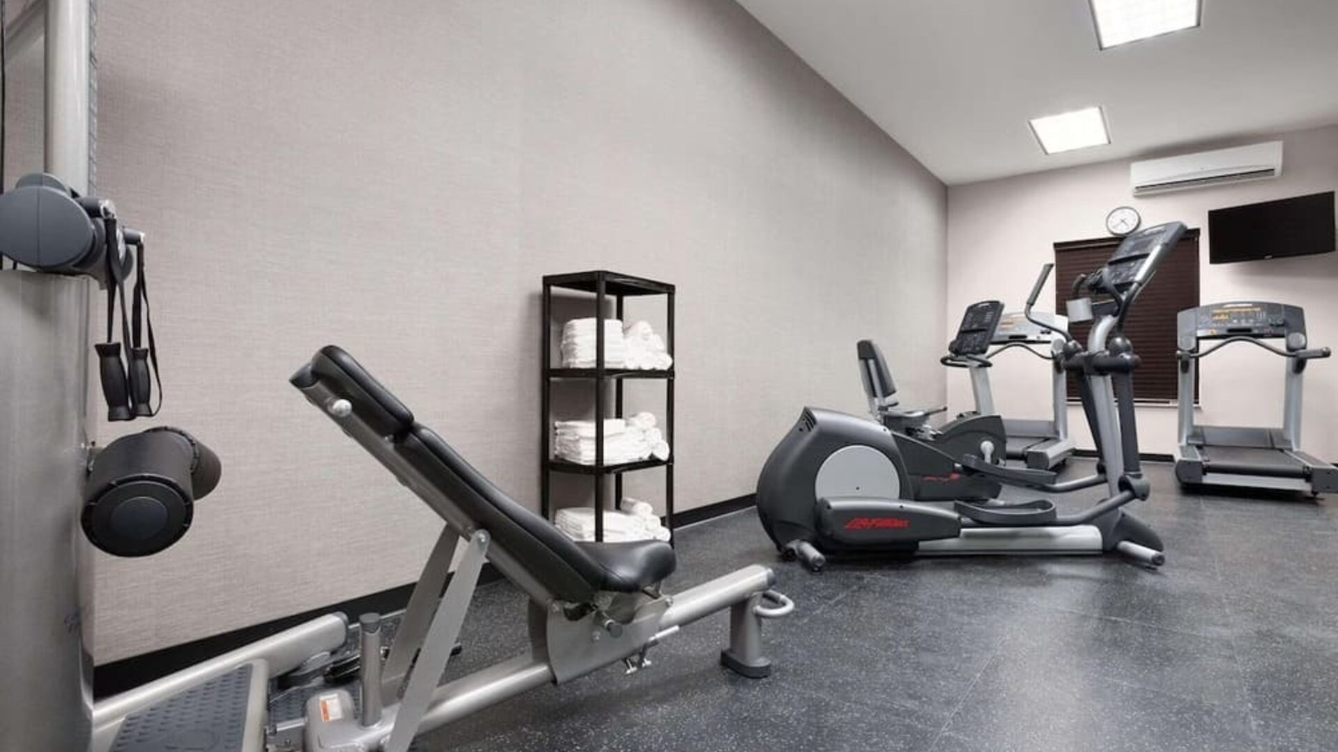 Fully equipped gym at Country Inn & Suites By Radisson, Katy - Houston West to meet all your fitness needs.