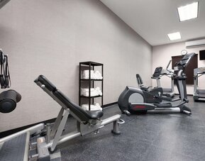 Fully equipped gym at Country Inn & Suites By Radisson, Katy - Houston West to meet all your fitness needs.