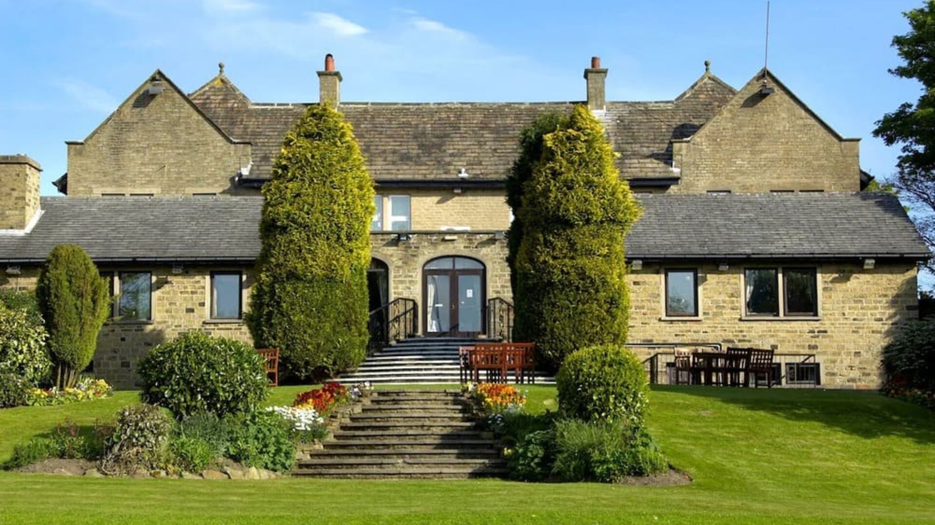 Beautiful garden with seating area at The Old Golf House Hotel.