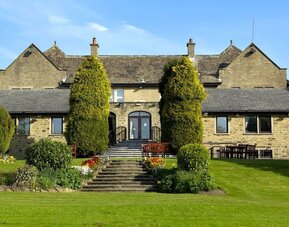 Beautiful garden with seating area at The Old Golf House Hotel.