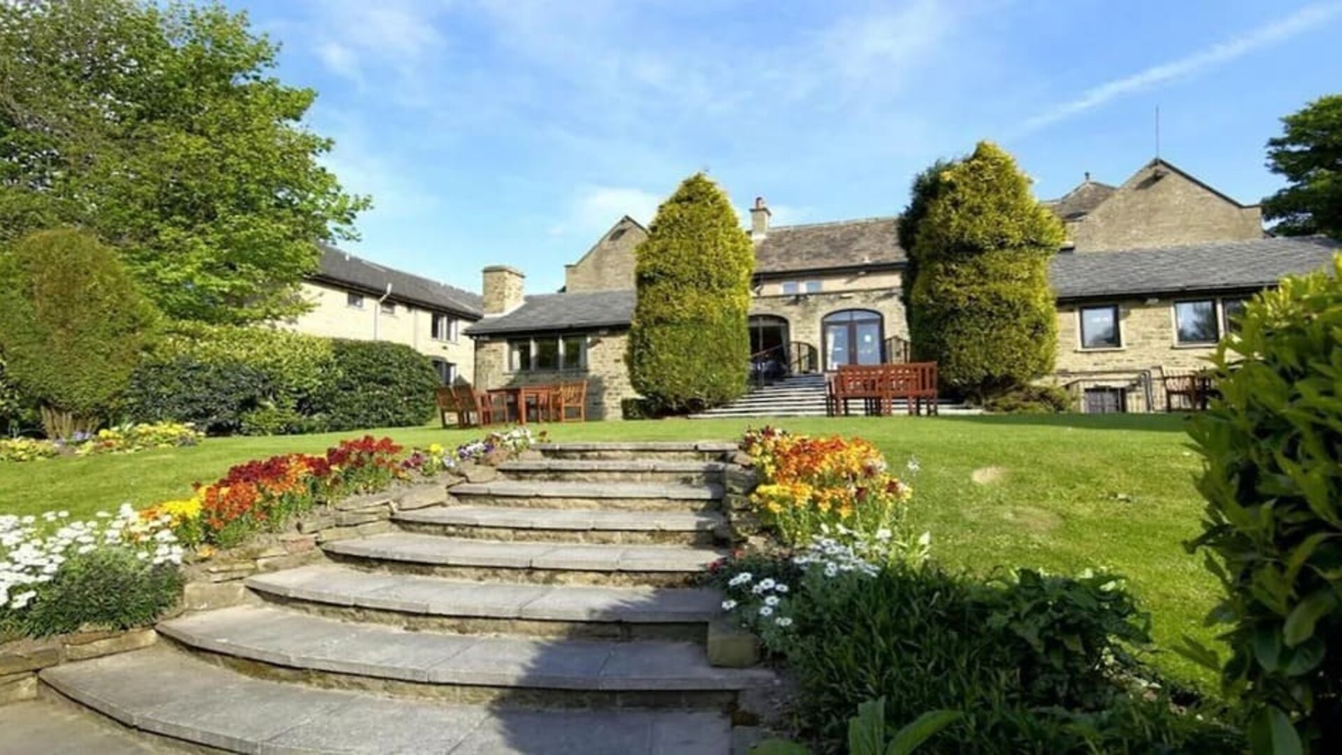Beautiful garden with seating area at The Old Golf House Hotel.