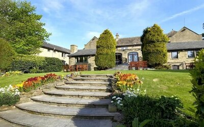 Beautiful garden with seating area at The Old Golf House Hotel.