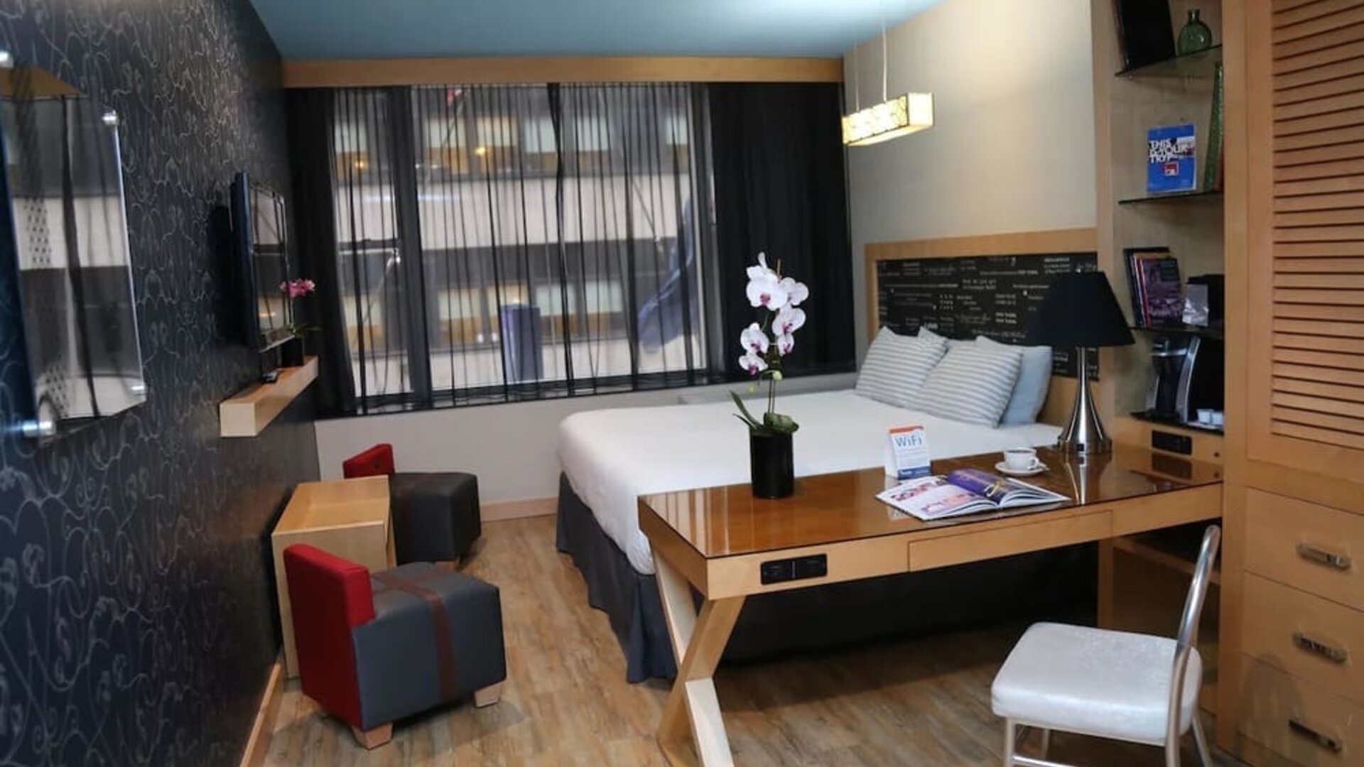 Room at the TRYP By Wyndham Times Square South containing desk, bed, and a television.