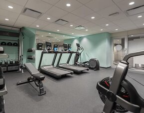 Fitness center with treadmills at Tru By Hilton Montreal Centre-Ville.
