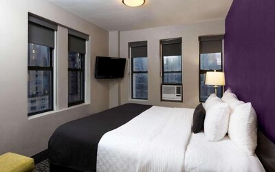 Day use room with a television and a view of the city at La Quinta Inn & Suites By Wyndham New York City Central Park.