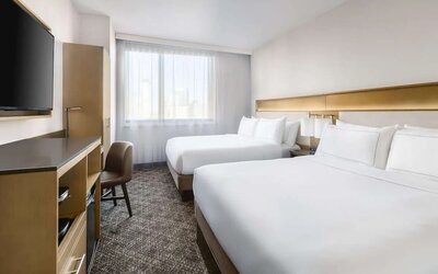 Guest room in the DoubleTree Times Square South, with a workspace desk and chair.