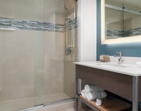 Modern bathroom with plush towels at EVEN Hotel Brooklyn By IHG.