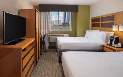 Day room at the Holiday Inn Express Times Square’s with workspace and a televison.