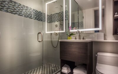 Beautiful, modern bathroom with plush towels at The Bernic Hotel New York City, Tapestry Collection By Hilton.