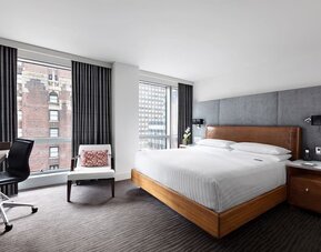 Day use room with workspace, large windows and natural light at Hotel 48LEX New York.