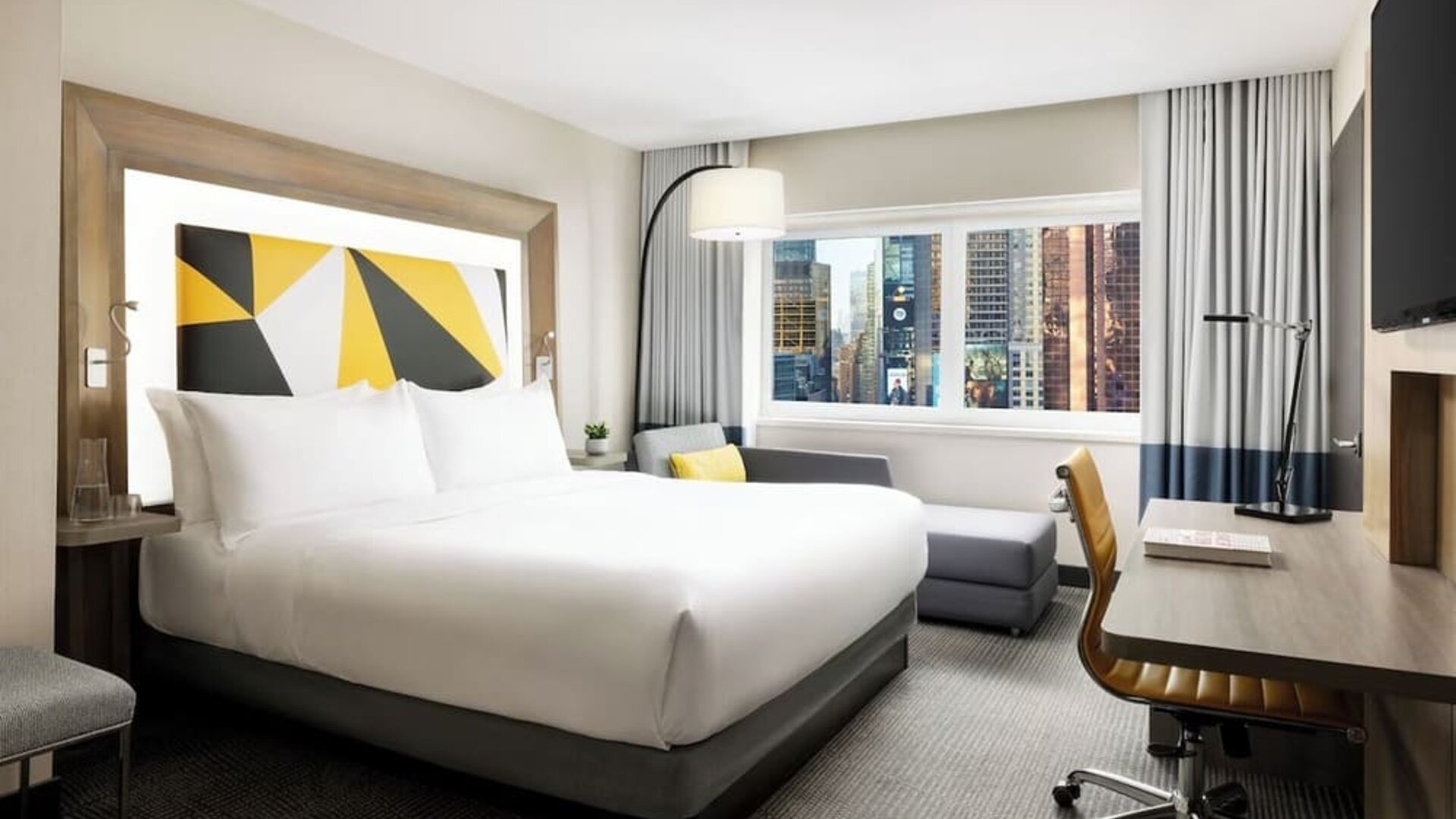 Day use room with workspace and natural light at M Social Hotel Times Square.