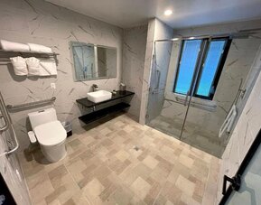 Modern bathroom with plush towels at Liberty View Brooklyn Hotel.